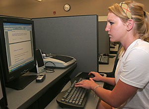 Pre-business freshman Caroline Thompson works on an assignment at the Disability Resource Center computer lab yesterday. DRC students will lose the privilege of registering early for classes starting spring semester.   