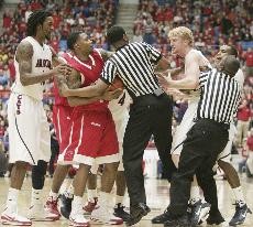Officials and players from both teams try to break up a scuffle after Houston guard Aubrey Coleman stepped on UA forward Chase Budingers face. Coleman issued an apology the following day, but that didnt stop upwards of 4.6 million people from seeing a video post of the incident on YouTube.