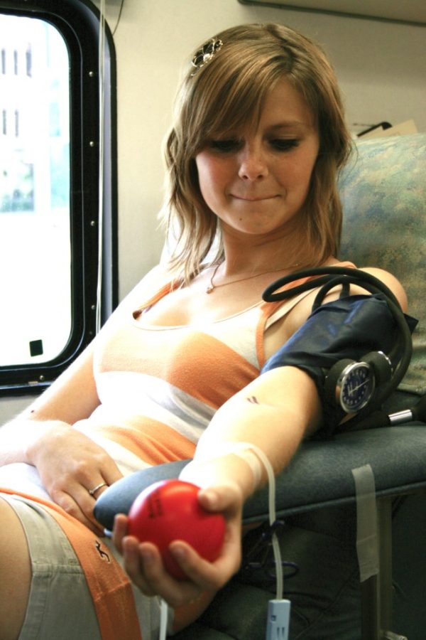 Andrea Ruth, architecture junior, sits while blood is being drawn from her arm for a blood drive on Aug.31 on a Donor Bus outside Campus Health. The bus has a goal of 25 donations per day. Amir Adib/ Arizona Daily Wildcat