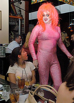 Christopher Newman, a social studies education senior and president of Delta Lambda Phi, dances in a sparkly pink jumpsuit and wig at Colors nightclub, 5305 E. Speedway Blvd., last night. Newman and other members of Delta Lambda Phi performed to raise funds to purchase a charter for their fraternity, one of the last steps to being officially recognized.