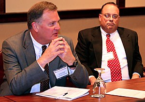 Bruce Wright, associate vice president for economic development at the UA, speaks about immigration concerns as R. F. Shangraw Jr., executive director of decision theater at Arizona State University, listens at a conference where the Southwest Border Security Consortium met yesterday afternoon.