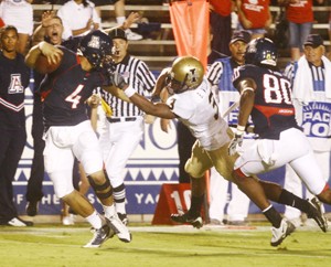 UA reserve quarterback Matt Scott (4) tries to escape the grasp of defensive back Breyon Williams in a 70-0 win over Idaho at Arizona Stadium on Aug. 30. Scott and other reserves on the team are anticipating ample playing time at Washington State on Saturday.