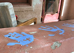 Members of the Arizona Model United Nations left their handprints in blue paint on the porch of their former house after they were told it was to be demolished.