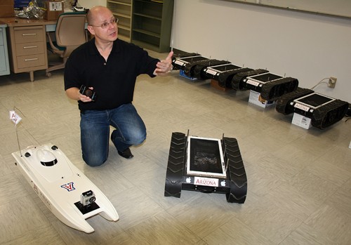 Annie Marum / Arizona Daily Wildcat

Wolfgang Fink, Associate Professor in Electrical an Computer Engineering, stands with his planetary robots that are operated via IPhone. 