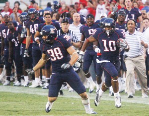 UA special teams player Orlando Vargas (38) looks to make a block on a punt return during the Wildcats 48-14 win over Washington Saturday night at Arizona Stadium. Vargas and fellow special teams player Tito Foster - the self-proclaimed Smash Brothers - have impressed coaches with all of their hard work in a non-starring role on the team.