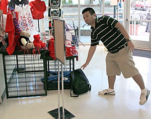 Reginald, a pre-business freshman, drops his backpack by the front door as he walks into the Arizona Bookstore, 845 N. Park Ave., on Tuesday. Both of the Arizona Bookstore locations are enforcing the security measure more strictly this semester.  