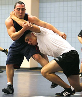 Ben Papermaster, a business sophomore, right, tries to tip Akiva Kurland, a nutrition junior, in the Student Recreation Center Tuesday. The Arizona club wrestling team has made the sports biggest revival since the UA varsity team ended in 1981.