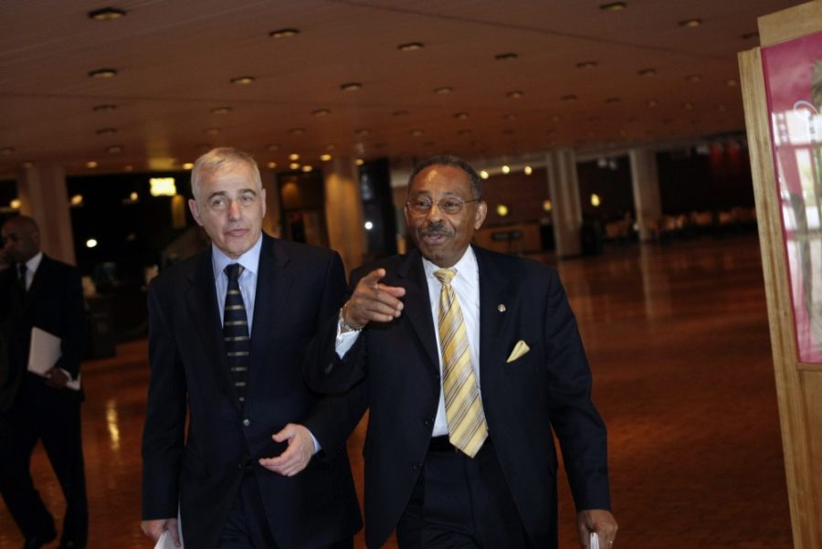 U.S. Sen. Roland Burris (D-Ill.) walks with University of Illinois chancellor Richard H. Herman as the two make their way to a meeting with other school representatives in Champaign, Illinois, on Wednesday, May 27, 2009.