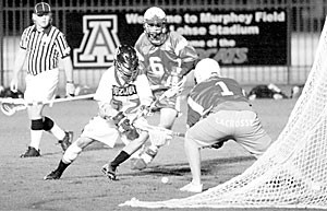 Sophomore attackman Christian Burrows fights for the ball in an attempt to score last night against Simon Fraser sophomore goalie Aaron Pascas. Arizona won the match 18-11, gaining its second victory of the season in as many games.