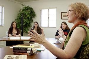 Barbara Whittlesey, administrative associate in the Honors College, discusses potential book ideas with a group of Honors College students.  They are working on the freshman booklist for next year.
