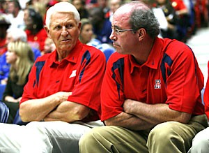 Arizona mens basketball coach Lute Olson, left, sits with interim head coach Kevin ONeill. Olson will return to the team next season.