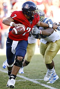 UA quarterback Willie Tuitama slips out of the hands of UCLA defensive tackle Kevin Brown during the Wildcats 34-27 win over the Bruins on Saturday. Tuitama is one of the players to say that questions about head coach Mike Stoops job security didnt affect the Wildcats performance.  