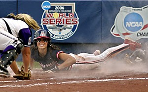 Sophomore right fielder Adrienne Acton, right, looks to the home plate umpire after sliding safely past Northwestern catcher Jamie Dotson, left, to score in the third inning of the first game of the 2006 NCAA Division I softball championship in Oklahoma City yesterday.  Arizona defeated Northwestern 8-0 and will play for the schools first NCAA championship since 2001 tonight.