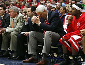 UA head coach Lute Olson cant bear to watch his team as freshman Nic Wise, right, coordinator of basketball operations Jesse Murmeys, near left, associate head coach Jim Rosborough, middle left, and assistant coach Josh Pastner, far left, look on. Olsons squad lost 92-64 to No. 4 North Carolina Saturday afternoon and has lost five of its last seven games. 