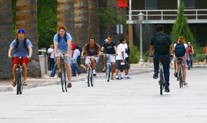 Bike traffic along the concrete vehicle accesses of the UA Mall can often become crowded, forcing pedestrians wayward onto the sidewalks and grass.