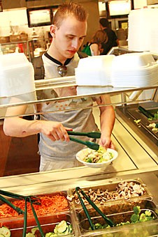 Cole Wellendorf, a media arts junior, fashions himself a leafy meal at the Cactus Grill salad bar yesterday afternoon.