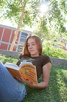 Biology freshman Monica Fumo takes a break from finals studying to read Tom Robbins Fierce Invalids Home from Hot Climates, in the park behind Posada San Pedro Residence Hall yesterday afternoon.