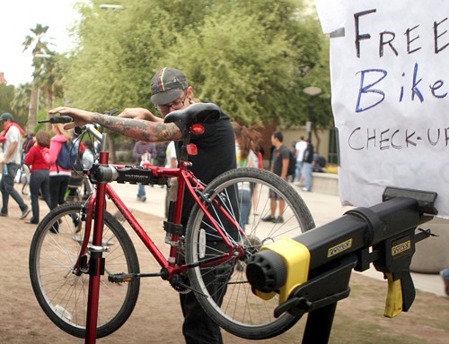 Valentina Martinelli / Arizona Daily Wildcat 

Colin Holmes, 25, a mechanic at Bicas performs a free bike checkup as part of a celebration of Earth Day on the UA mall on April 22, 2010.  Local businesses and organizations took part in this event by selling environmentally friendly products and having raffles and contests.