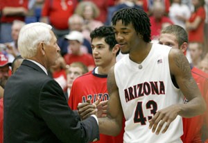 Arizona sophomore forward Jordan Hill shakes hands with head coach Lute Olson during yesterdays Senior Day festivities after the Wildcats 68-66 loss to the No. 4 UCLA mens basketball team. It was Olsons first public appearance in McKale Center this season after taking a leave of absense Nov. 4.