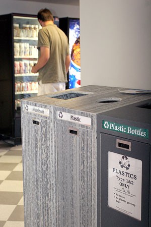 Kaleb Badger, a media arts sophomore, purchases a drink behind Manzanita-Mohave Residence Hall recycling area, located in the kitchen, yesterday. The dorms are trying to raise awareness about the environment by heavily promoting recycling.