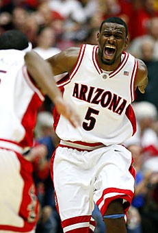 UA junior guard Jawann McClellan celebrates after hitting a 3-pointer with four seconds left in the first half of Arizonas 71-47 win over ASU in McKale Center last night. McClellan made 3 first half-3pointers and scored 14 points in the game after going without a 3-pointer  in the last five games. 