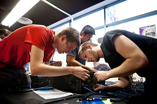 University of Arizona team, (L to R) Taylor Kvarda, Jesse Zhang, Brandon Kvarda, builds the AMD Fastest Computer, a game where students have to design, build, troubleshoot and tune a PC the fastest.  The Avnet Tech Games were held in Tempe and each member of the winning team received a $1,000 scholarship.