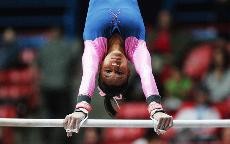 Arizona freshman Rebecca Cardenas performs her routine on the uneven bars during a loss to No. 4 Stanford Friday night in McKale Center. Cardenas scored a career-high 9.825 on the event and recorded a 9.875 on the floor exercise, leading the Wildcats in both events.