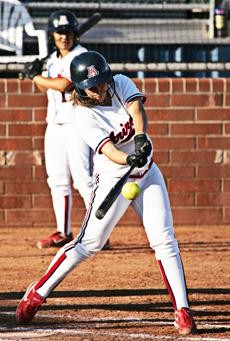 UA sophomore Corinna Gonzalez connects with a pitch during a 9-0 Arizona win against Simon Fraser Tuesday night at Hillenbrand Stadium. The Wildcats outscored The Clan 20-0 during a doubleheader sweep.