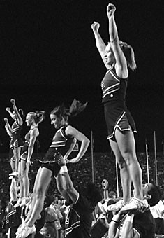 UA cheerleaders perform partner stunts at the football game versus Stephen F. Austin Saturday night. Despite the Pac-10 not recognizing cheerleading as an official sport, they did decide to ground the cheer teams from performing a variety of stunts, including basket tosses and tumbling.