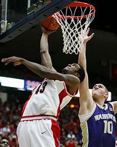 Arizona forward Jordan Hill goes for a reverse layup over Washington center Spencer Hawes during the second half of No. 20 Arizonas game against Washington Saturday in McKale Center. Arizona beat Washington 84-54, and Hill led the Wildcats with career highs in points (16) and blocks (five).