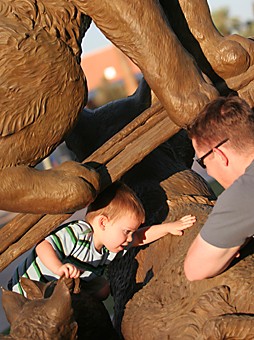 Jake Lacey / Arizona Daily Wildcat

UA Alum Mark Deason and his son Jake play on the Wildcat Family statue on the mall yesterday. Deason says they often spend time around campus waiting for his wife to finish classes for the day.