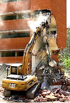 Ted Seely of Breinholt Contracting works on demolishing part of the Franklin buildings east stairwell yesterday. The building, which housed the Journalism department and the Near Eastern Studies department, will be replaced by a new building for the Family and Consumer Sciences department.