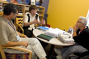 Michael Barr, left, a training manager, Aaron Foster, middle, a senior in special education and rehabilitation, and Sue Kroeger, director of the UA Disability Resource Center, plan out their ideas for the Mental Health Awareness Week yesterday afternoon.  