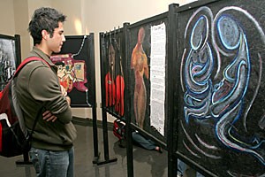 Pre-physiology freshman Ivan Zacarius gazes at the art in the gallery of the Student Union Memorial Center yesterday. The display,  called Inside/Outside, was created by Ohio teenagers,  exemplifying their feelings on female incarceration.