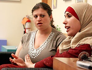 Judaic studies junior Drew Alyeshmerni, left, and Muslim Student Association president Sarah Dehaybi, a biology senior, discuss their successes this year and prepare the Tucson Peace Project on Monday night for next semesters activities. The club involves both Jewish and Muslim students working together to form a student peace alliance as a model for the Mideast peace process.