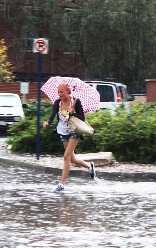 Lisa Beth Earle/ Arizona Daily Wildcat

Marie Fleming, a pre-business freshman, runs through flooded Tyndall street on Tuesday, Aug. 24, 2010. The San Diego native, accustomed to light drizzles of rain, was very surprised by the sudden downpour.