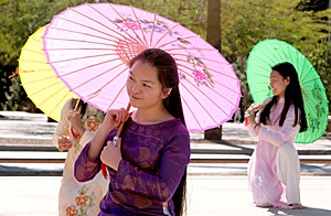 Accounting and fine arts junior Thanh ha Tran, left, and marketing junior Mai Dinh, both members of the Vietnamese Student Association, perform their traditional Umbrella dance yesterday on the UA Mall. Their dance performance kicked off Awareness Week 2006, an event sponsored by ASUA Pride, APASA and CHSA.