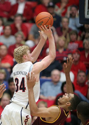 Arizona forward Chase Budinger shoots over a falling Jeff Pendergraph in ASUs 59-54 win over the Wildcats in McKale Center on Sunday. Budinger scored four points, tying a career-low, in the game and shot just 1-for-12 from the field.