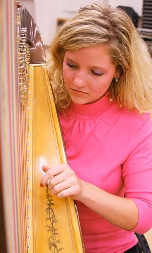 Fine arts senior Agnes Hall practices on her harp Oct. 13 with the HarpFusion group in preparation for their Takin on the World concert on Oct. 18 at Crowder Hall at the UA School of Music.