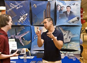First year physics grad student, Michael Wohlhoefler, left, speaks with Jason Jou, a recruiter with Boeing Co., yesterday during the UA Spring Career Days at the third-floor ballroom of the Student Union Memorial Center. Spring Career Days continues today, featuring over 100 employers looking to hire students.