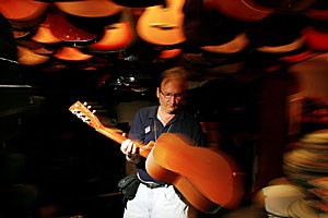 Mark Levkowitz, one of the owners of the Chicago Music Store, sorts through one of the thousands of guitars upstairs in the store. Levkowitzs family has been collecting the guitars upstairs for more than 80 years, which is how long they have owned the store.
