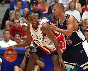 Former Wildcat point guard Sean Elliot plays keep away with former guard Miles Simon at the Lute Olson All-Star Classic yesterday afternoon in McKale Center. The event reunited former basketball players from the 1997 national championship team as well as players from throughout the Olson era.