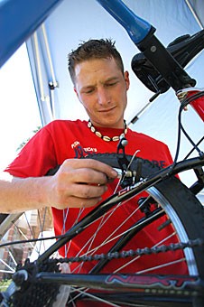 Kyle Colavito, a mechanical engineering graduate student and UA cycling club member, works on a students bike. The cycling club was on the UA Mall yesterday helping students with their bikes and promoting their club.