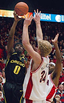 Oregons Aaron Brooks drains the game-winning shot over Arizonas Chase Budinger, left, and Mustafa Shakur during the closing seconds of Sunday nights game in McKale Center. Brooks, who tied the game with a 3-pointer minutes earlier, finished with 21 points.