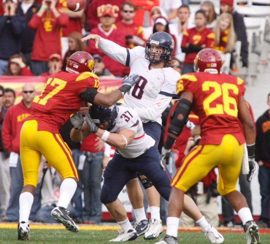 Arizona quarterback Nick Foles gets rid of the ball in the face of a USC attack on Saturday. The Wildcats enter the Holiday Bowl faced off against Nebraska and its stingy defense led by Ndamukong Suh on Dec. 30.