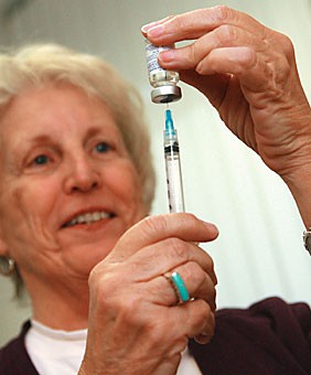 Judy Stivers, a nurse at the Campus Health Service immunization office, holds up a polio vaccine - a less common vaccine used only for travelers headed to Africa and parts of southeast Asia. Recent mumps outbreaks at college campuses nationwide serve as a reminder to keep up on immunizations. 