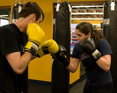 Meredith Lisse, a pre-public health junior,  and Thomas Ireson, a mechanical engineering junior, practice boxing to get a workout at Boxing, Inc at 2524 N. Campbell Ave. Boxing Inc  offers classes,  sparring and  individual work out sessions with a trainer.  