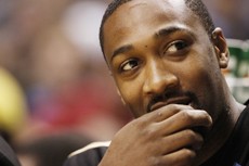 Washington Wizards guard Gilbert Arenas watches from the bench during a 124-115 Wizards loss to the Indiana Pacers on Sunday night in Indianapolis. Arenas, a former Wildcat, said the next UA mens basketball head coach needs to be able to bring in highly-talented recruits to get the program back to where it was under Lute Olson. 