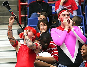 Freshmen Kai Lindstedt, left, and Joe Blanco cheer on the Arizona gymnastics team in leotards at Feb. 23s meet against ASU in McKale Center. These self-proclaimed super-fans have cheered on the Gymcats at every home meet this year while dressing up, waving signs and making noise.