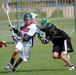 UA midfielder Shane Morrison runs up field while being defended by Oregon attack Julian Coffman in Arizonas 13-12 loss to Oregon Saturday at Murphey Field. Morrison recorded an assist for the No. 11 Laxcats, who scored five goals in the final quarter but came up one short against the No. 1 Ducks.